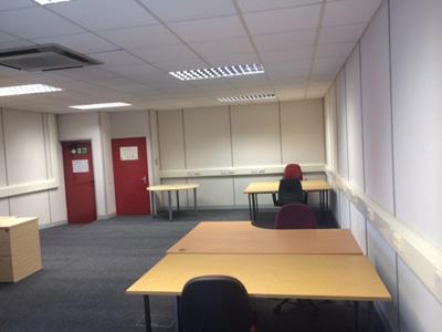 An empty office at Mansley Business Centre Serviced Offices with lights on and sample office furniture on display at Timothys Bridge Road, Stratford-upon-Avon, Warwickshire.